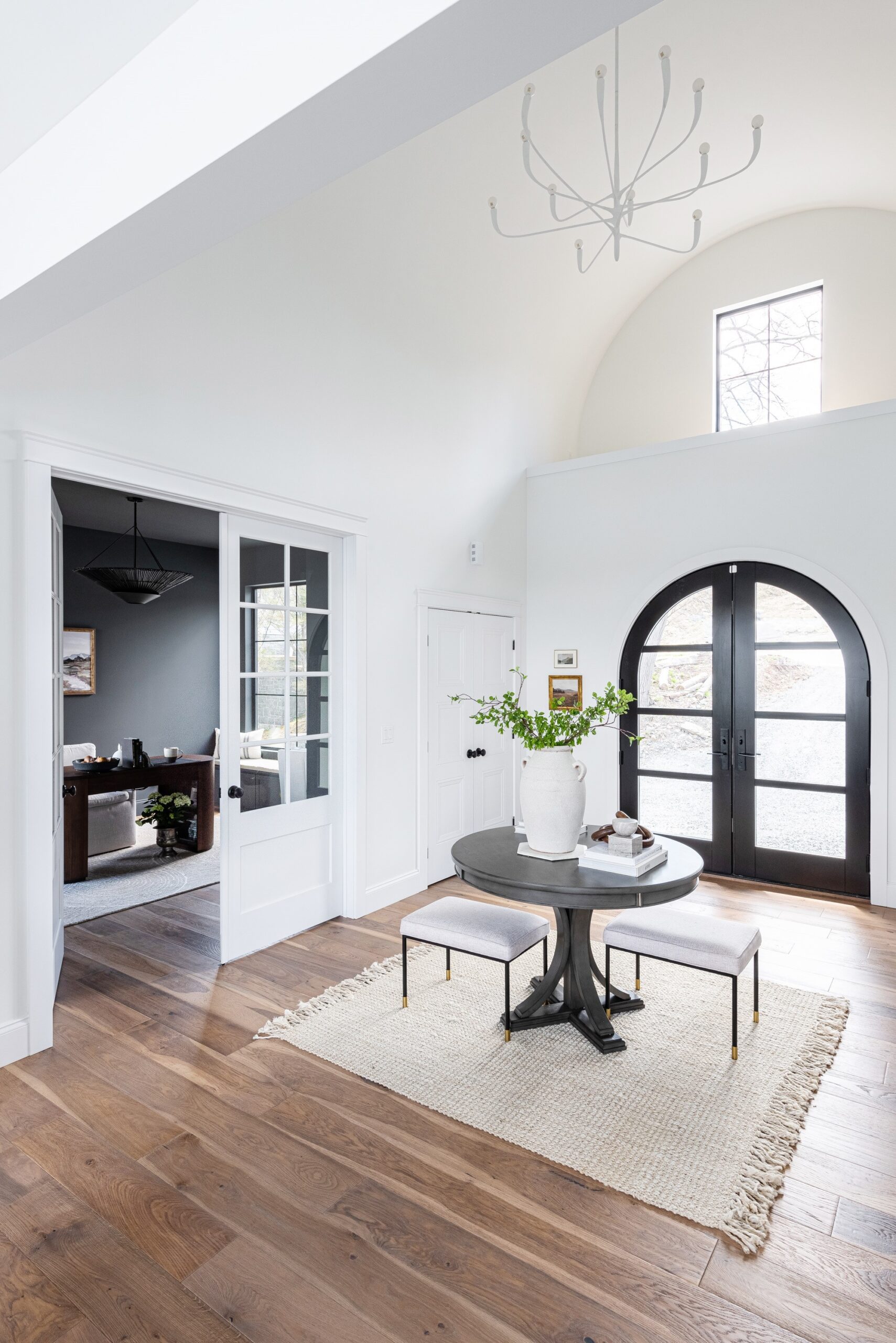 Hudson Valley Lighting's Labra Chandelier hangs elegantly in the vaulted white ceiling. The white alabaster finish is subtle and graceful against the white ceilings