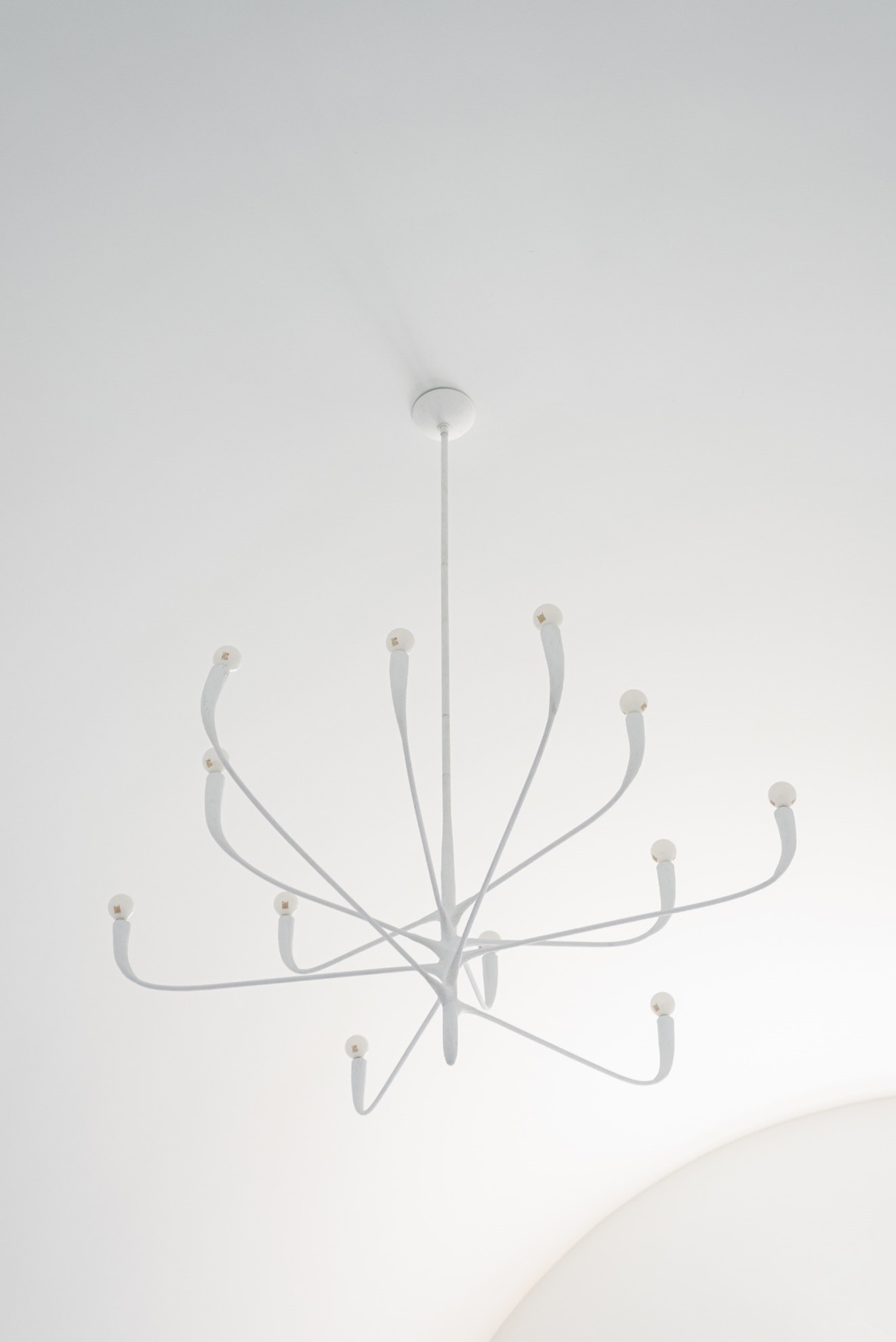 Hudson Valley Lighting's Labra Chandelier closeup of alabaster finish against a white, high vaulted ceiling